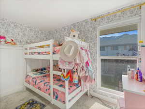 Bedroom with wallpapered walls and carpet flooring