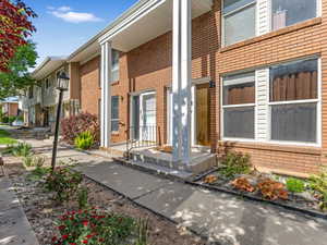 Property entrance featuring brick siding
