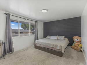 Carpeted bedroom featuring baseboards