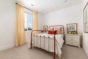 Carpeted bedroom with baseboards and recessed lighting