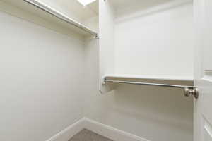 Walk in closet with carpet floors