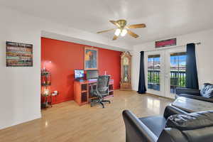 Office with french doors, wood finished floors, a ceiling fan, and baseboards