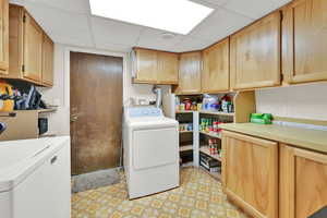 Laundry area with cabinet space and washing machine and dryer