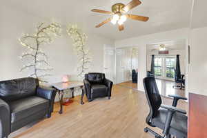 Office with a ceiling fan, wood finished floors, and baseboards