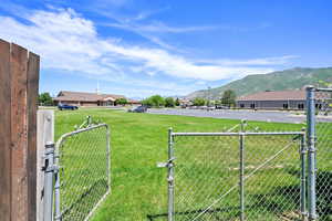 View of yard with a gate and a mountain view