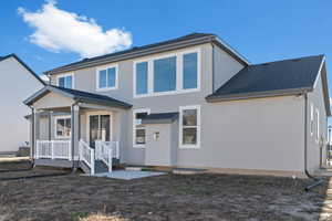 Back of property featuring stucco siding