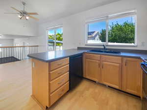 Kitchen with dishwasher, a sink, light wood-style flooring, ceiling fan, and a peninsula