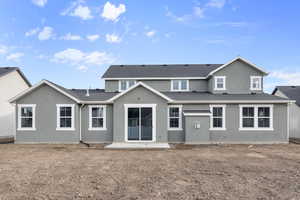 Back of house with stucco siding and a patio area