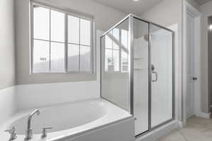 Full bathroom with a stall shower, a bath, and marble finish flooring