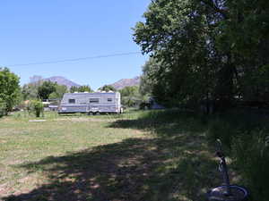 View of yard with a mountain view from SW corner of lot, looking East
