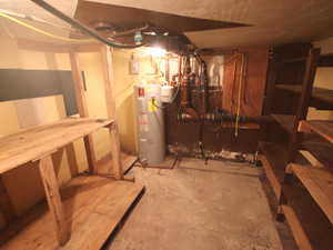 Unfinished basement featuring water heater