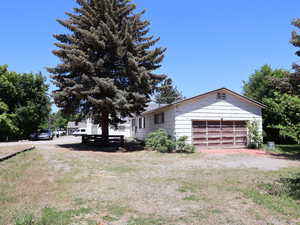 View of yard with an attached garage, looking from the South to North