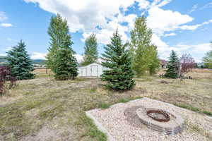 View of yard featuring an outdoor fire pit