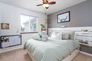 Bedroom featuring carpet flooring, baseboards, and ceiling fan