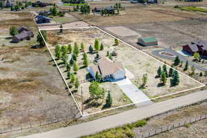Aerial view of sparsely populated area with property parcel outlined