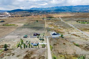 Overview of rural landscape with property parcel outlined and a mountain backdrop