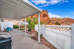 Fenced backyard featuring a patio area, area for grilling, and outdoor dining space