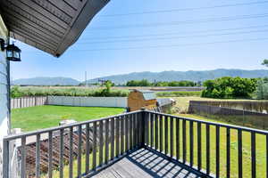 Deck featuring a mountain view and a fenced backyard