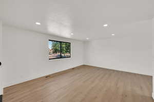 Spare room with recessed lighting and light wood-style flooring