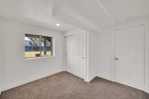 Unfurnished bedroom featuring carpet flooring, a closet, and recessed lighting