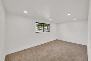 Spare room featuring carpet flooring and recessed lighting