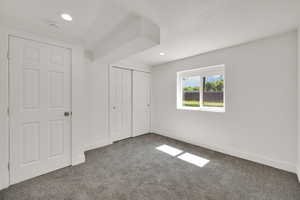 Unfurnished bedroom featuring carpet, recessed lighting, and a closet