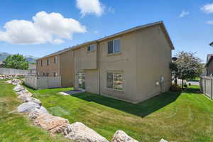 Rear view of house with stucco siding and a mountain view