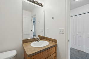 Half bath featuring vanity and toilet