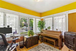 Home office with wood finished floors