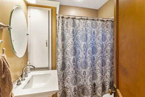 Full bathroom with a shower with shower curtain and vanity