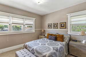 Bedroom with carpet floors and baseboards