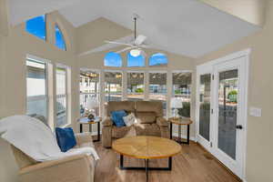 Sunroom / solarium with wood finished floors and high vaulted ceiling