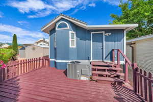 Wooden deck featuring central AC unit