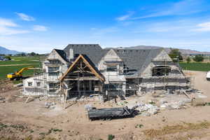 Back of property featuring a mountain view and stone siding