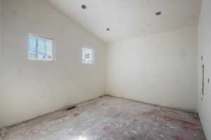 Spare room with vaulted ceiling