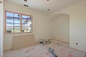 Spare room featuring arched walkways