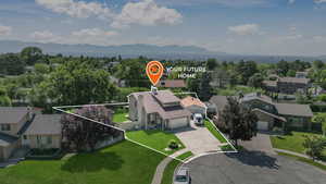 Aerial perspective of suburban area featuring mountains and property boundaries highlighted