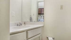 Bathroom with washer / clothes dryer and vanity