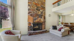 Living area featuring carpet floors and a fireplace