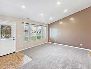 Tiled foyer featuring carpet flooring, recessed lighting, and baseboards