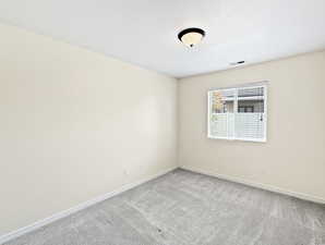 Unfurnished room with carpet flooring and baseboards