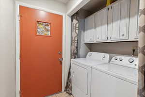 Laundry room featuring washer and dryer and cabinet space