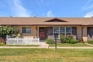 Single story home with brick siding and roof with shingles