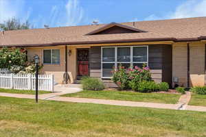 Ranch-style home with brick siding and a shingled roof