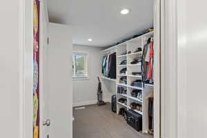 Primary Spacious closet with carpet floors