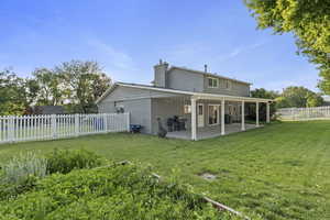 Back of house featuring a patio and a chimney