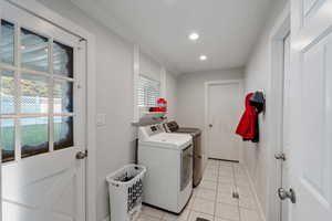 Washroom featuring independent washer and dryer, light tile patterned floors, recessed lighting, and baseboards