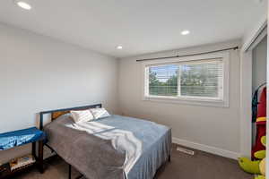 Carpeted bedroom featuring recessed lighting and baseboards