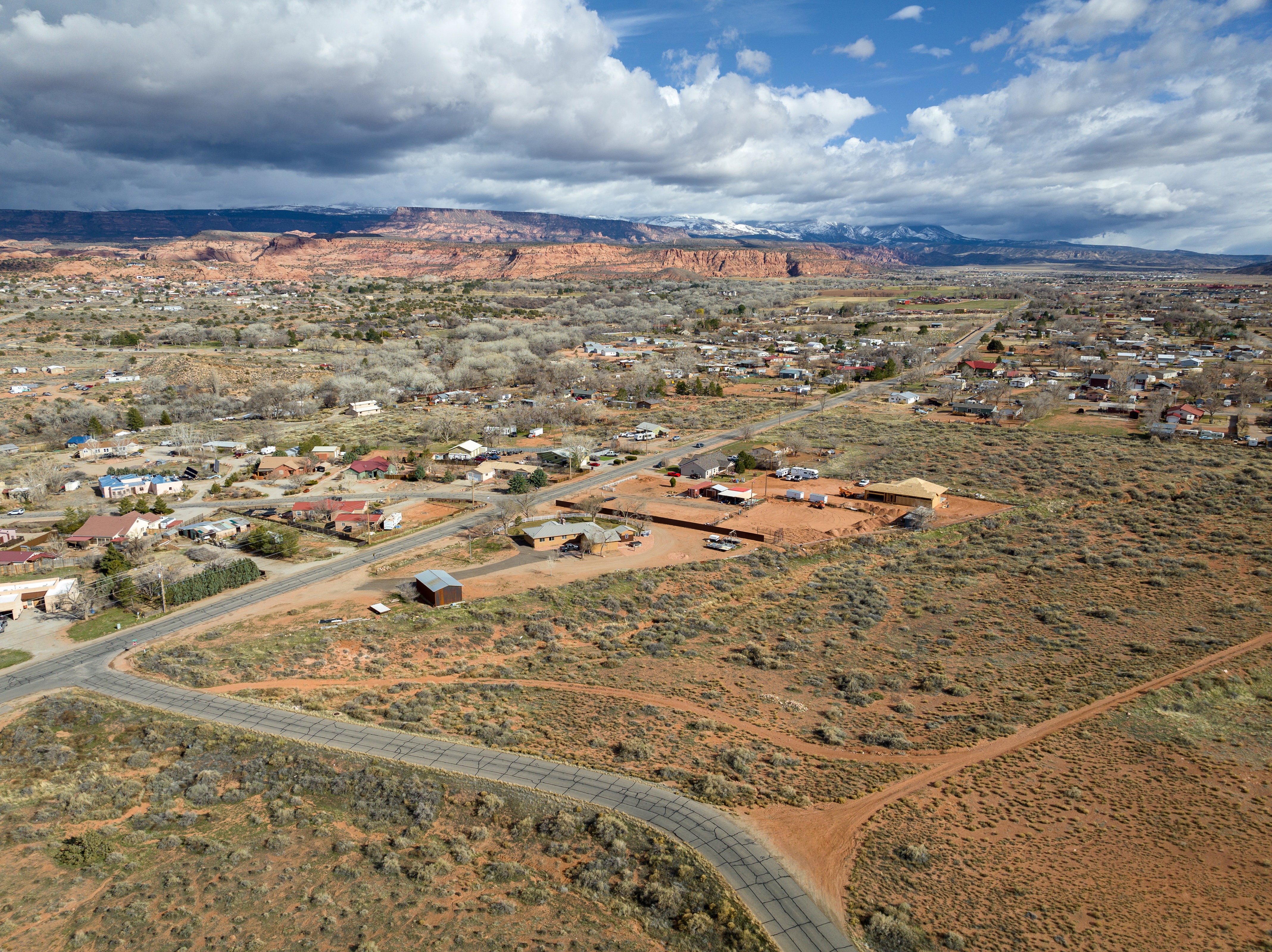 Aerial overview of property's location featuring a mountain backdrop and rural landscape