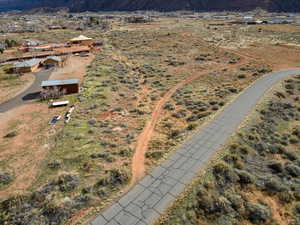 Aerial view of property and surrounding area featuring a mountainous background